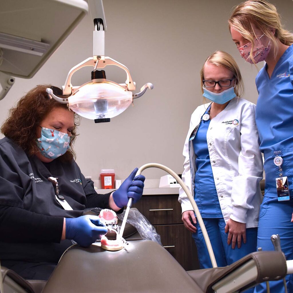 MedQuest College Comprehensive Dental Assisting students observing a technique by the instructor