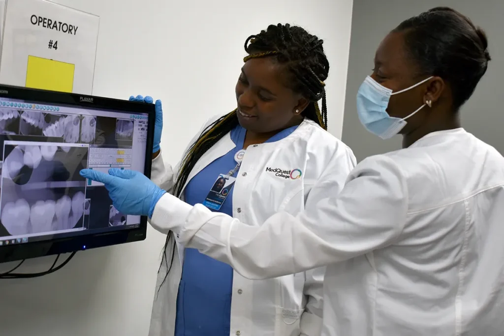 two dental hygienist students looking at screen