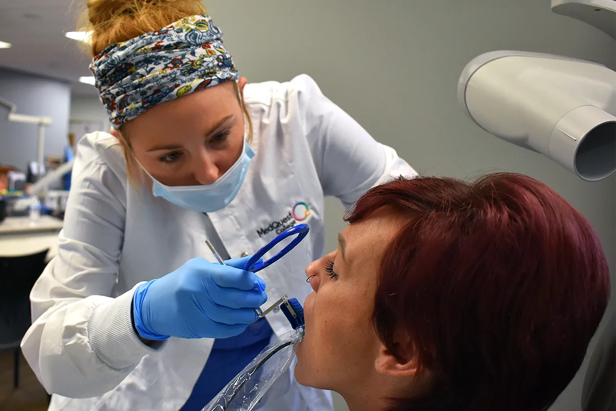 dental hygienist student preparing patient for an x-ray