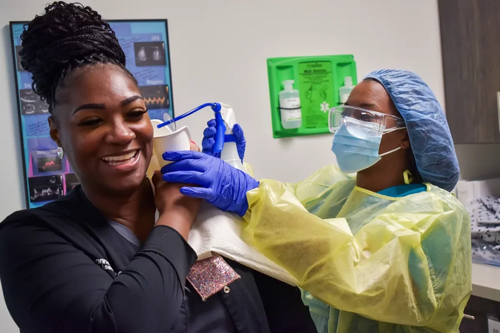 medical assistant student working with a teacher