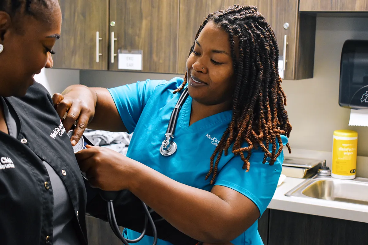 medical assistant student taking blood pressure