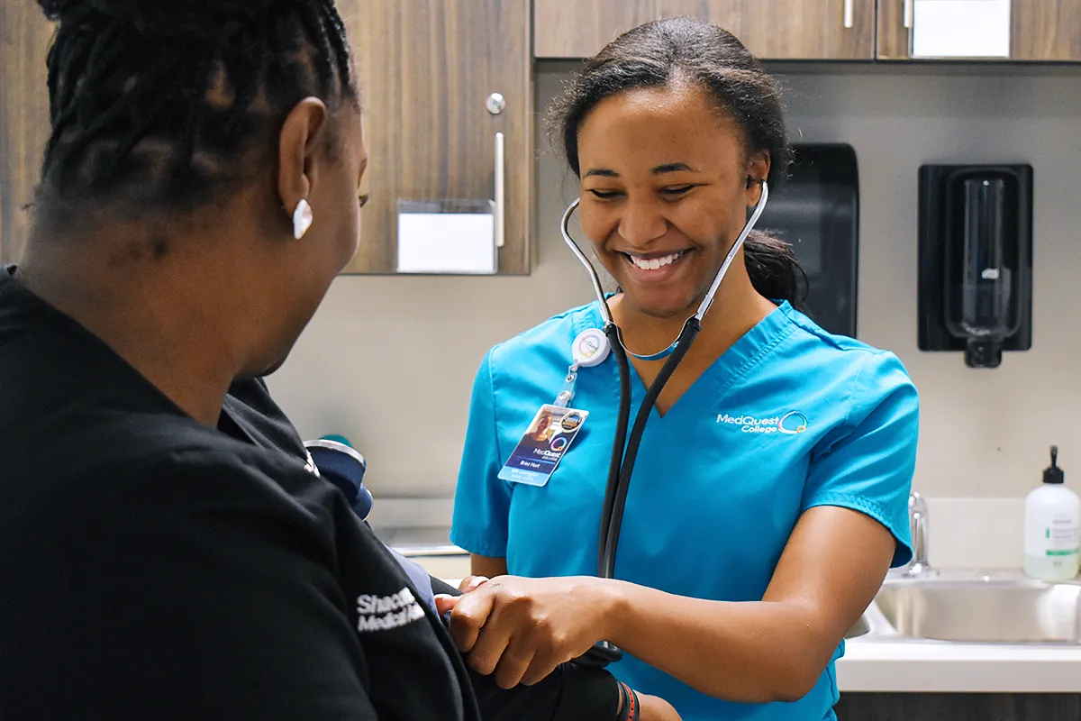 medical assistant student working with a patient
