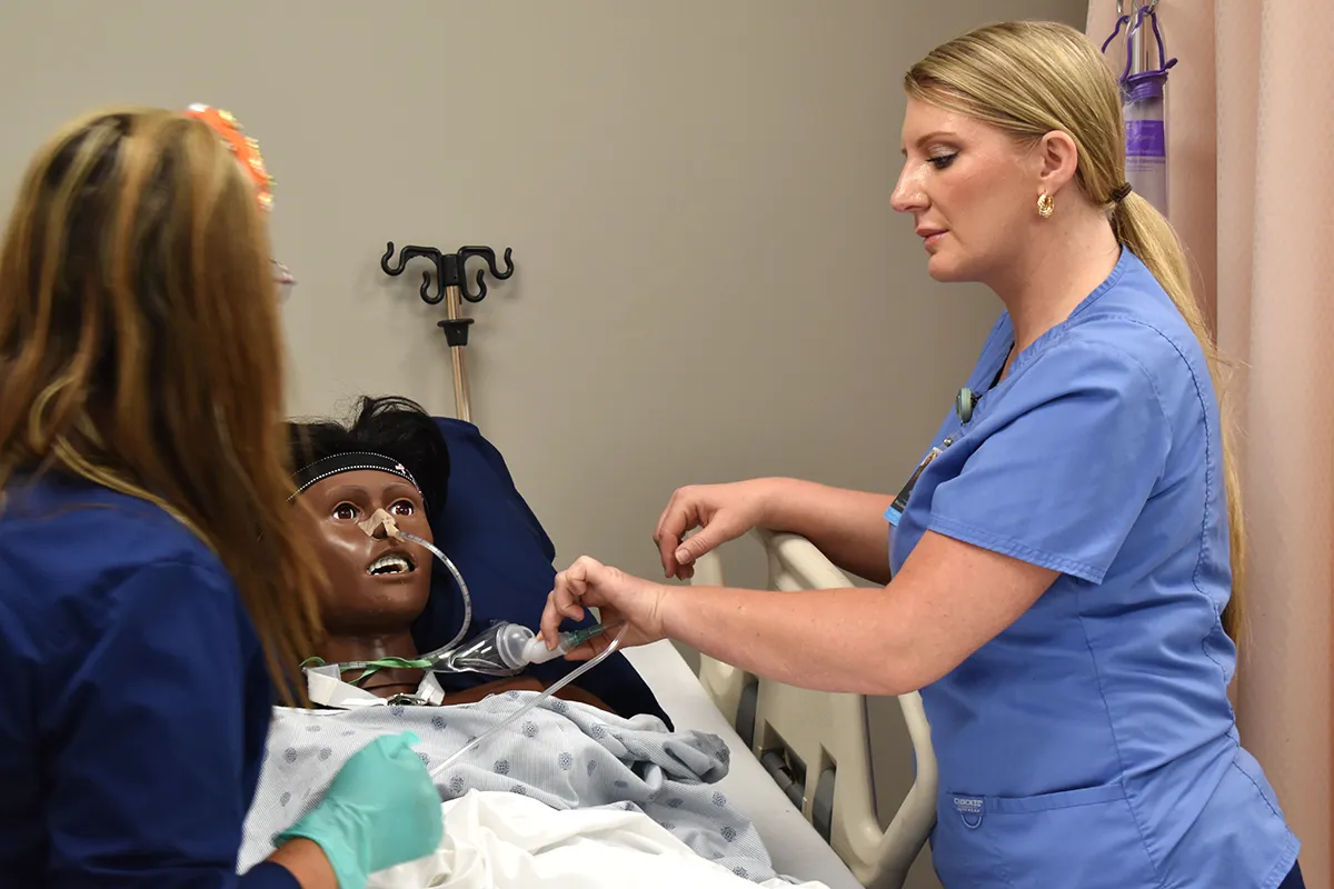 nursing students working on a fake patient