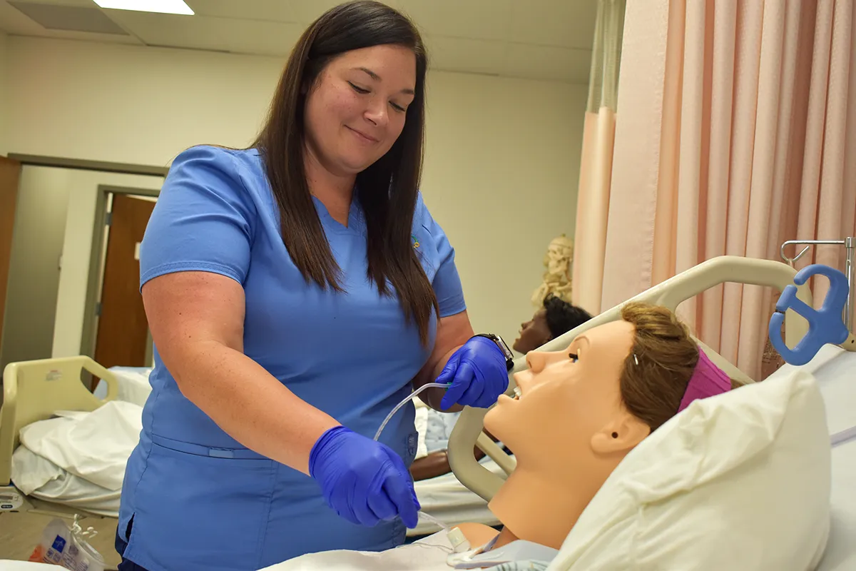 nursing student working on a mannequin